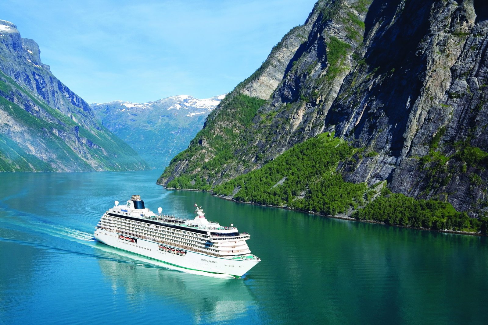 Cruise ship sailing through a Norwegian fjord