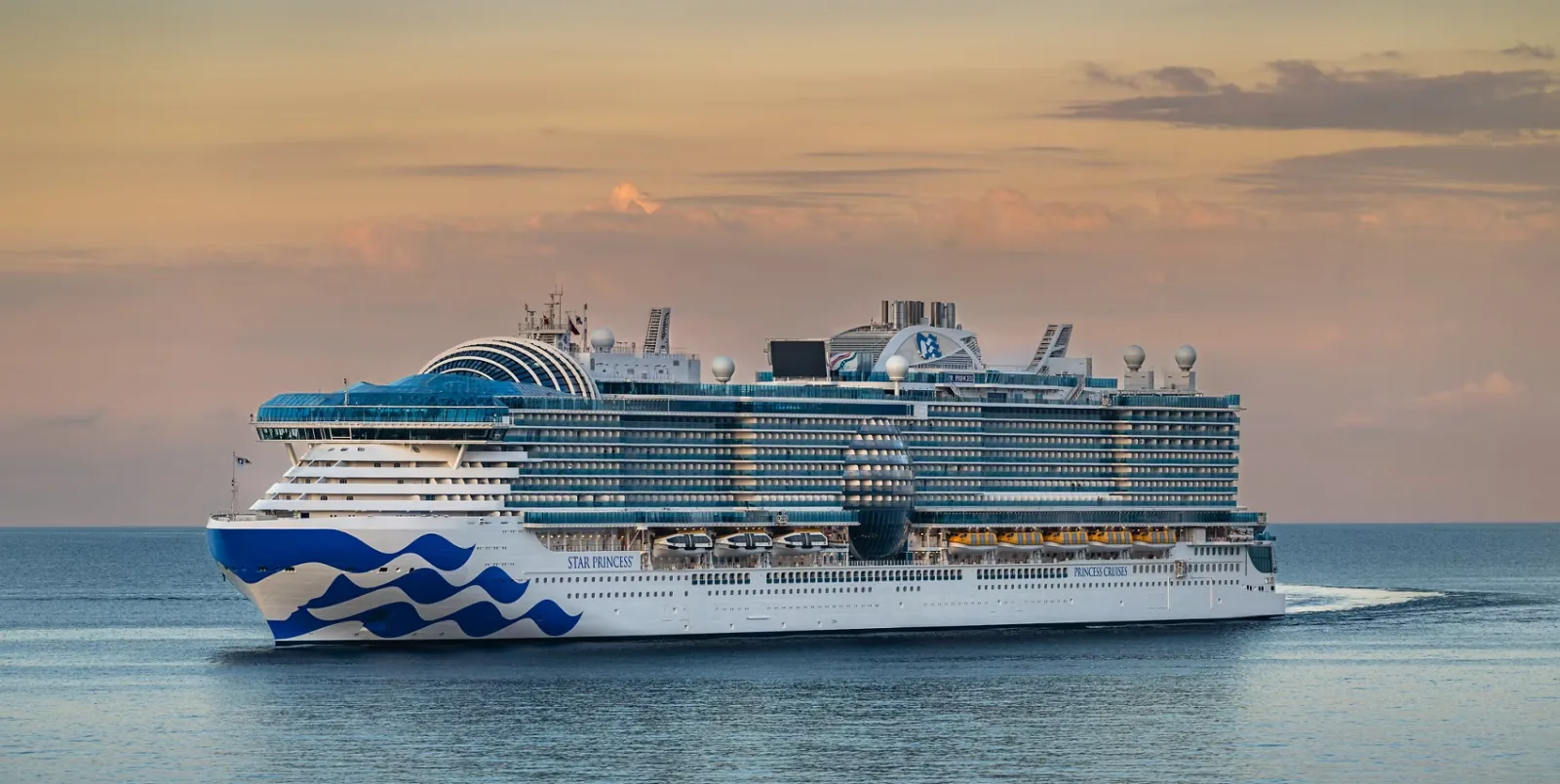 Cruise ship sailing at sunrise