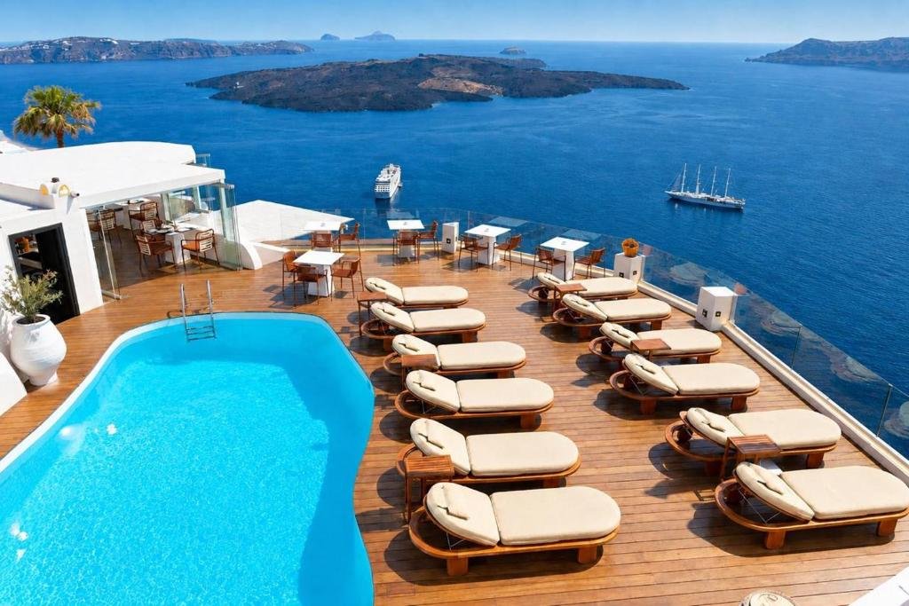 Clifftop pool terrace overlooking a cruise ship in Santorini